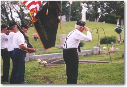 As Taps plays, the veterans bow their heads and salute