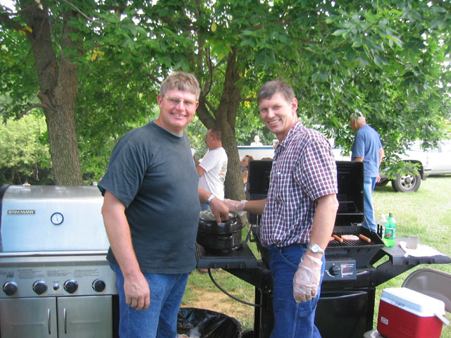 Carl and Don Kinsey grill food for the crowd at the tractor pull.