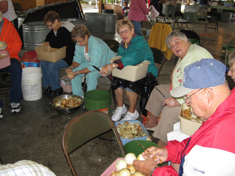 Maxine Crawford, Janet Stucker, Rosalie Schone, Barbara Fowler and other volunteers peel onions on Thursday, in preparation for the cooks starting the soup cooking on Thursday night.