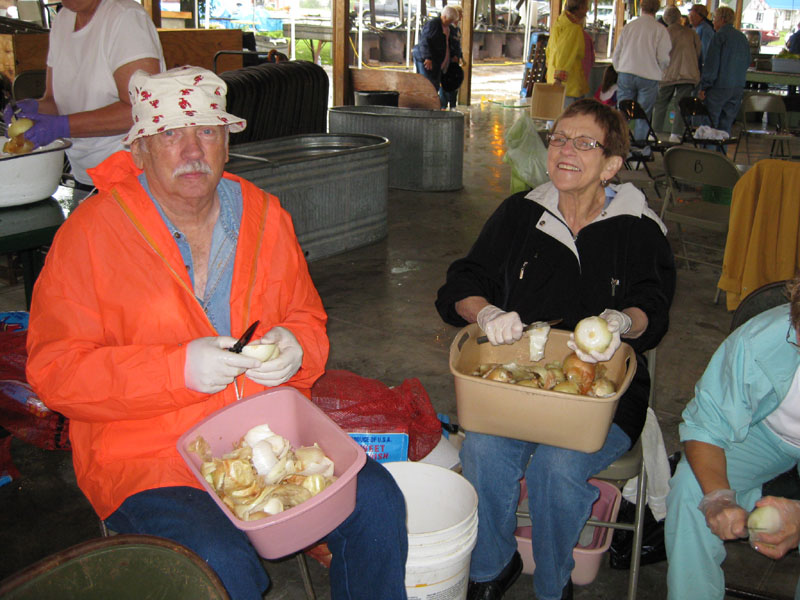 Don Nickel of Colorado Springs, CO, and Maxine Crawford visit while they peel onions.