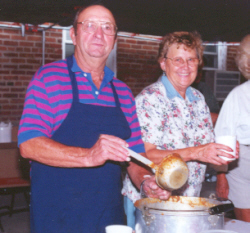 Lorenz Kleinschmidt and Althea Carls serve bowls of soup to hungry customers.