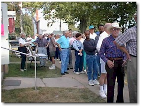 A long line forms around the village library for the supper hour. Soup was sold out around 6:30 pm.
