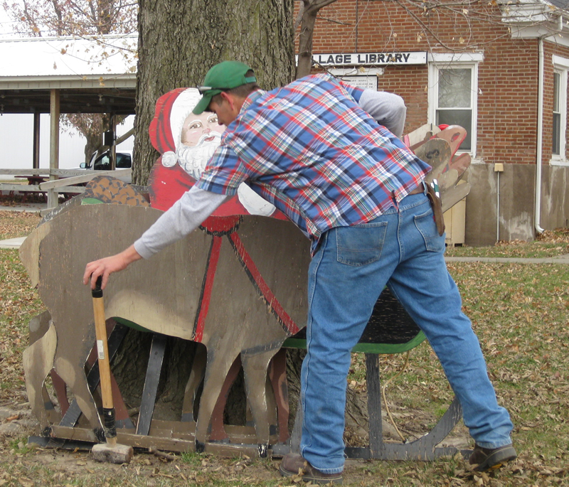A team of volunteers was out in the park on Saturday morning, arranging the Village's holiday display.