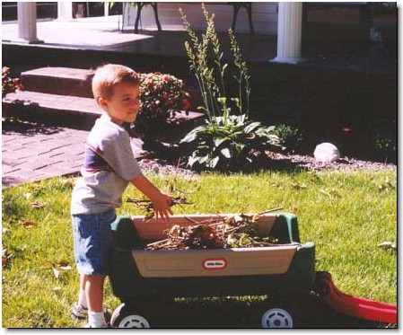 Working with somewhat smaller equipment, Adam H. helps out in his dad's yard.